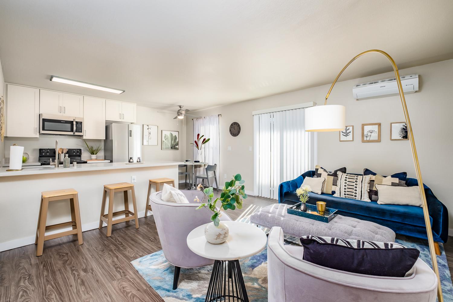 Updated apartment interior with open kitchen, living area, and modern finishes